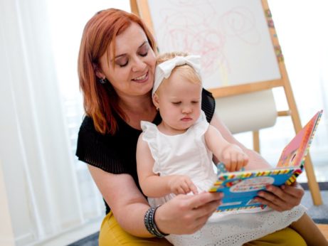 Silvia číta anglickú knižku dieťaťu, ktoré ukazuje na obrázok